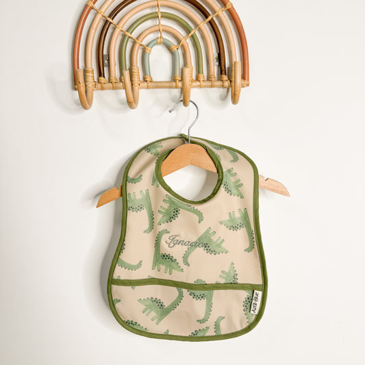 Babero con bolsillo dinosaurio